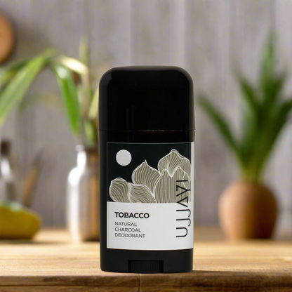 Person applying Ujjayi Tobacco Deodorant natural charcoal‑infused aluminum‑free stick to underarms for 24‑hour odor protection